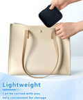 Lightweight beige leather tote bag with long handles and small black pouch for convenient storage.