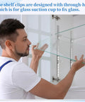 Person installing 8 Pcs 40 Inch Shelf Pilaster Tracks with Adjustable Metal Shelf Clips on a glass shelf in a cabinet.