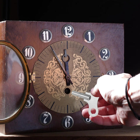 Person using Two Pack Wrench Clock Keys For Winding Clocks, 3.8mm Hole, 52mm Long Steel Clock Keys on a vintage clock