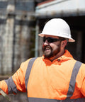 Worker wearing Tinted Safety Glasses 12 Pack ANSI Z87 Plus UV Eye Protection For Construction, Outdoor Work, And Industrial Safety