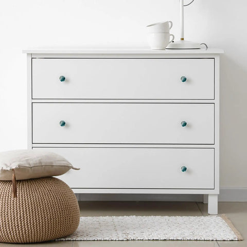 Level Up Your Space With These Seriously Dope 4 Pack Marble Look Cabinet Knobs on a white dresser with three drawers.