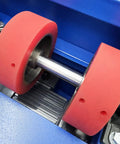 Close-up of Heavy Hitter 110 Volt Electric Drum Rotator Mixer rollers with red rubber wheels for drum blending tasks.