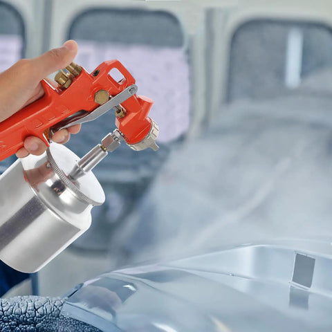Pro Grade Handheld Paint Sprayer With Precision Flow Control For Cars Tables And Cabinets spraying paint in garage.