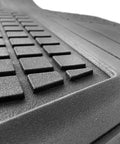 Close-up of built tough heavy duty trimmable cargo mat liner with deep traction grips in classic black, showing texture.