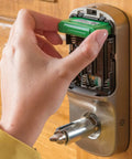Keyless Smart Door Lever Lock With Backlit Keypad And Auto Relock For Front Entry installation with batteries visible in solid bronze finish.