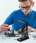 Man using LED Magnifying Lamp With USB Power for Soldering and Electronics Repair, Welding Clamp Light on workshop table