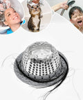 Dome-shaped stainless steel hair catcher for tub and shower drains with silicone rim, preventing hair clogs, focus on top view