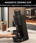 Top Shelf Electric Conical Burr Coffee Grinder Single Dose Fresh Roast Mill With Quick Stepless Dialing For Espresso Pour Over Drip And French Press In Clean White with magnetic dosing cup in use.