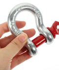 One Half Inch Galvanized Screw Pin Anchor Shackle Two Ton Kickass Lifting Rig For Trucks Built Strong With Zero Drama Off Road Tow Hook Mount Industrial Hardware Kit held in hand.