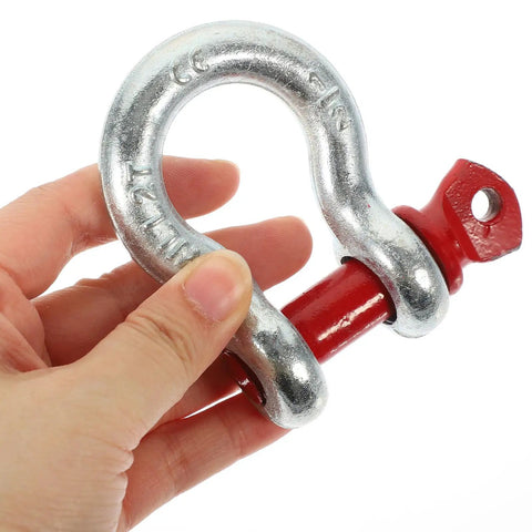 One Half Inch Galvanized Screw Pin Anchor Shackle Two Ton Kickass Lifting Rig For Trucks Built Strong With Zero Drama Off Road Tow Hook Mount Industrial Hardware Kit held in hand.