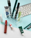 Eight Hole Transparent Acrylic Test Tube Rack For Fifty Milliliter Tubes Clear Durable Lab Organizer Stand on desk with pens