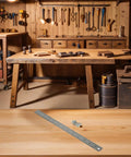 Pro Grade Steel Marking Gauge And Stop Ruler Set With 300mm Ruler displayed on a woodworking bench in a carpentry workshop.