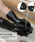 Person cleaning heat resistant BBQ gloves for grilling and cooking up to 220F under water in a sink, showcasing easy maintenance.