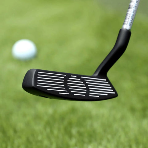 Close-up of 35 Inch Right Handed Golf Chipper With 32 Degree Loft, black head, focused on grooves, with golf ball on green.