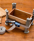 Workhorse Durable 1 Inch By 15 Inch Quick Grip Band Clamp with attached handle securing a wooden box project.