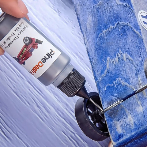 Applying Graphite Powder Lubricant 0.5 Oz for Pinewood Derby Cars and Wheels Axles, Dry Lube on blue wooden car wheel