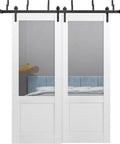 Barn Style Sliding Doors Set For Interior Use With Clear Glass And Solid Wood Panels White 84 By 96 Inches Bypass Doors Classic Look Hardware Included And Ready To Install, shown in a bedroom setting.