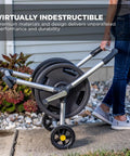 Person using 200 Foot Heavy Duty Aluminum Upright Hose Reel with Rust Proof Frame Leak Proof Brass Connections in garden