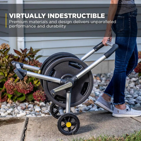Person using 200 Foot Heavy Duty Aluminum Upright Hose Reel with Rust Proof Frame Leak Proof Brass Connections in garden
