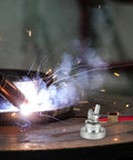 Industrial Pro Grade Magnetic Welding Grounding Clamp with slip free hold shown in action on a metal surface during welding