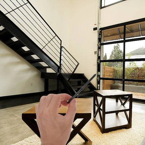 Four Pack Premium Stainless Steel Cable Railing Hardware Kit featuring threaded wire rope terminals held in hand near staircase.