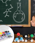 Child learning with Hands On Organic Chemistry Model Kit For Learning And Exploration, 444 Piece Molecular Kit displayed on table.