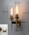 Antique Bronze Two Light Sconce For Bathroom Vanity With Dual Two Point Eight Inch Cylinder Glass Shades on wall