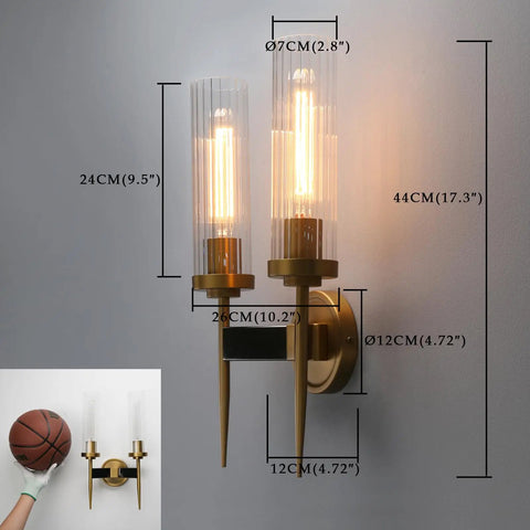 Antique Bronze Two Light Sconce For Bathroom Vanity With Dual Two Point Eight Inch Cylinder Glass Shades on wall