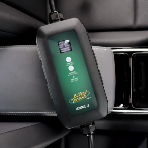 Dead Simple 16 Amp Level One Portable Ev Charger on car seat, digital screen displaying charge status and interface options.