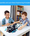 Robotic arm kit components for STEM toy on table; two kids assemble at home