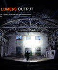 Beast 3000 Lumen Rechargeable Tactical Flashlight illuminating an abandoned warehouse interior, showcasing beam strength and range.