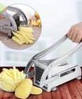 Stainless steel potato cutter with lever-operated handles for making French fries in the kitchen.