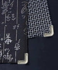 Close-up of 12 Pack Slick Metal Handbag Corner Protectors With Shiny Electroplated Finish for Purses, showing on black textured material.