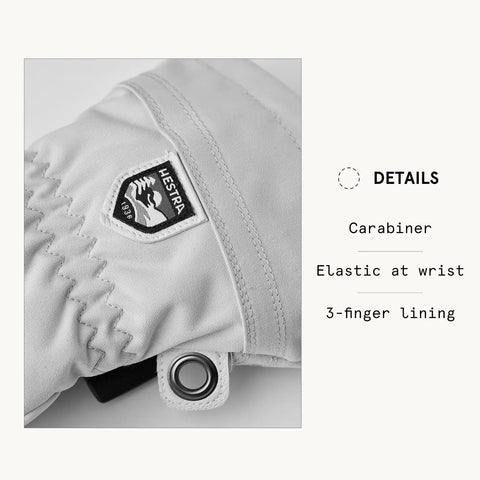 Close-up of Army Leather Heli Ski 3 Finger Women's Leather Snow Glove in misty grey with HESTRA logo and carabiner detail.