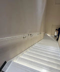 Hella Durable Acrylic Round Grab Handle With Rock Solid Metal Brackets on white modern staircase for safe indoor use.