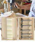 Front view of a 5-piece hinge jig drill bit set in a wooden storage box with metal bits