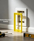 Single Gang Outlet Box Extender One Quarter Inch Snap On Wall Plate Gap Filler next to electrical outlet on wall.