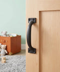 Black finish door pull on wooden closet showcasing 12 Pack 4 Inch Curved Door Pull Handles For Outdoor Warehouse Garage Shed Closet And Cabinet Smooth Burr Free Metal Pull Hardware For Fence Balcony And Restoration Projects With Easy Grip
