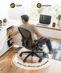 Man using office chair with "Office Chair Wheels Set Of 5 3 Inch All Black Casters 11x22mm Rubber Roller Blades For Carpet And Hardwood Floors Silky Smooth Glide With Quiet Bearings And Soft PU Shell Game Changing Comfort Safe For All Surfaces" showing smooth movement on hardwood floor.