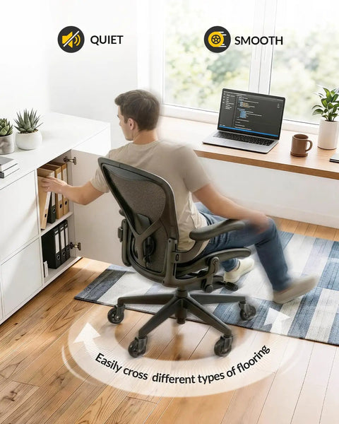 Man using office chair with "Office Chair Wheels Set Of 5 3 Inch All Black Casters 11x22mm Rubber Roller Blades For Carpet And Hardwood Floors Silky Smooth Glide With Quiet Bearings And Soft PU Shell Game Changing Comfort Safe For All Surfaces" showing smooth movement on hardwood floor.
