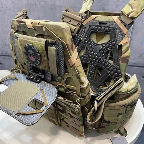 Camouflage tactical vest on display, showing multiple storage compartments and thick shoulder padding.