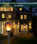 Solar Torch Lights With Realistic Flickering Flame 96 LEDs 43 Inch Outdoor Waterproof Landscape Lights illuminating a garden path