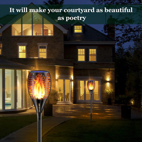 Solar Torch Lights With Realistic Flickering Flame 96 LEDs 43 Inch Outdoor Waterproof Landscape Lights illuminating a garden path