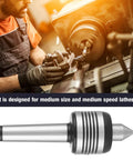 MT3 live center on metal lathe; side view of machinist at work.