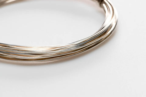 Close-up of coiled 12 Gauge 925 Sterling Silver Wire Dead Soft Square Made In USA 5 Ft for DIY jewelry making and wire wrapping projects.