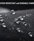 Close-up of droplets on black fabric showing water-resistant feature of Waterproof Travel Cable Organizer Pouch With Double Layer Storage.