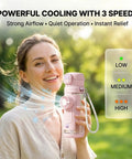Person holding 2-In-1 Hydration Bottle With Built-In Foldable Cooling Fan, 23 Oz Portable Dual Drinking Cup with 3-speed settings, outdoors
