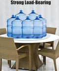 Rock Solid Tempered Glass Lazy Susan Rotating Serving Tray King Size Heavy Duty Silent Swivel Turntable For Centerpieces Kitchen Dining Room Smooth Operation Bad Ass Build and Easy Clean 34 Inch on a table with water bottles.
