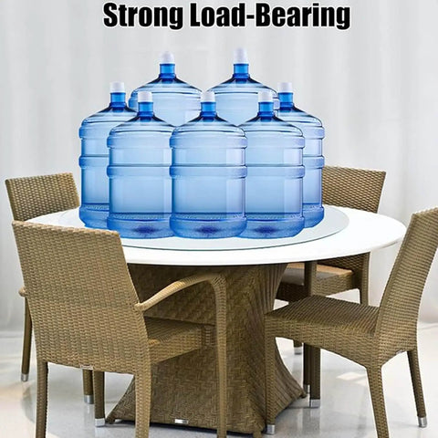 Rock Solid Tempered Glass Lazy Susan Rotating Serving Tray King Size Heavy Duty Silent Swivel Turntable For Centerpieces Kitchen Dining Room Smooth Operation Bad Ass Build and Easy Clean 34 Inch on a table with water bottles.