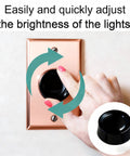 Close-up of hand using 2 Pack Black Rotary Dimmer Knob Replacement For Rotary Dimmer Switch And Fan Control on wall plate